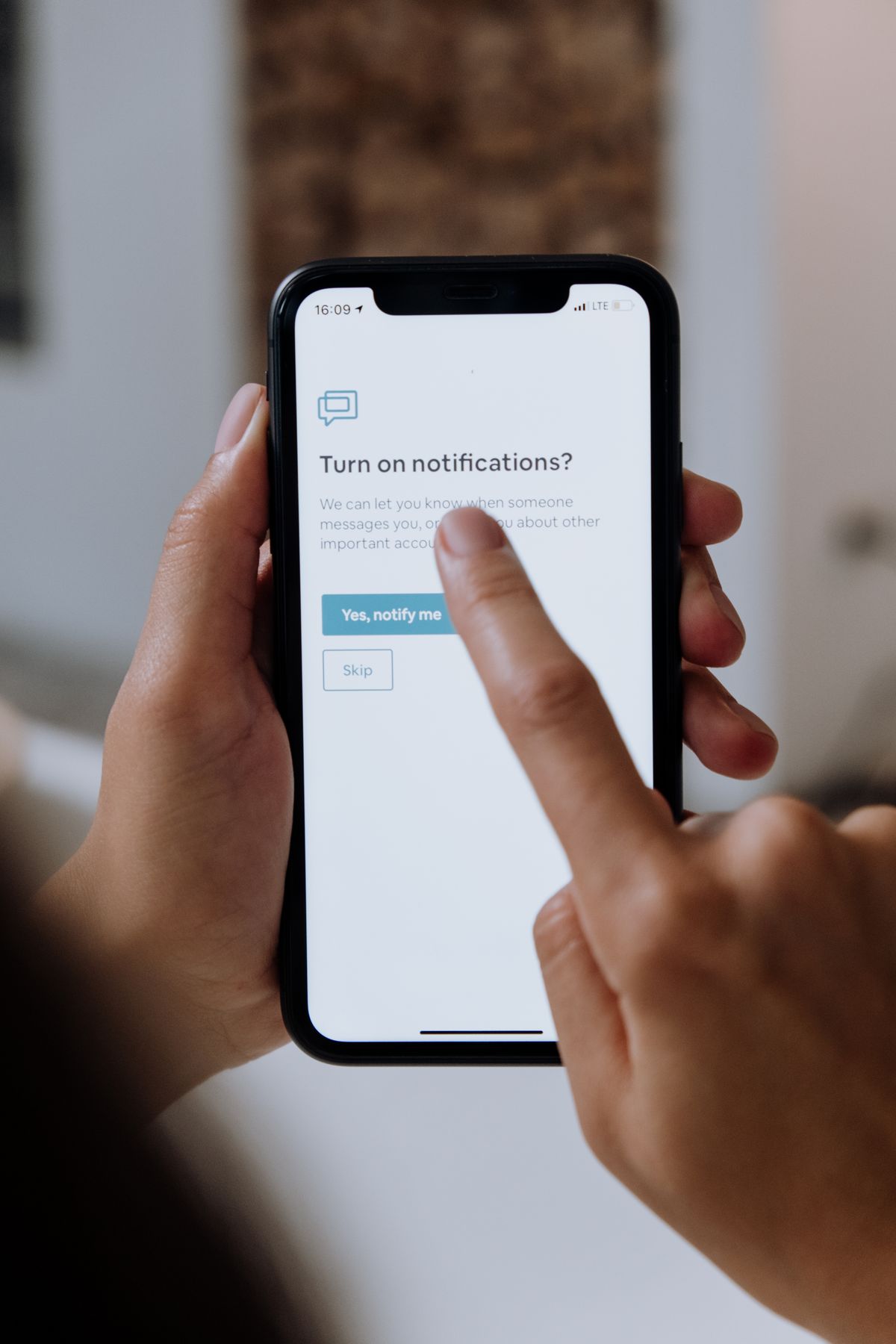 Person enabling instant notifications on a phone